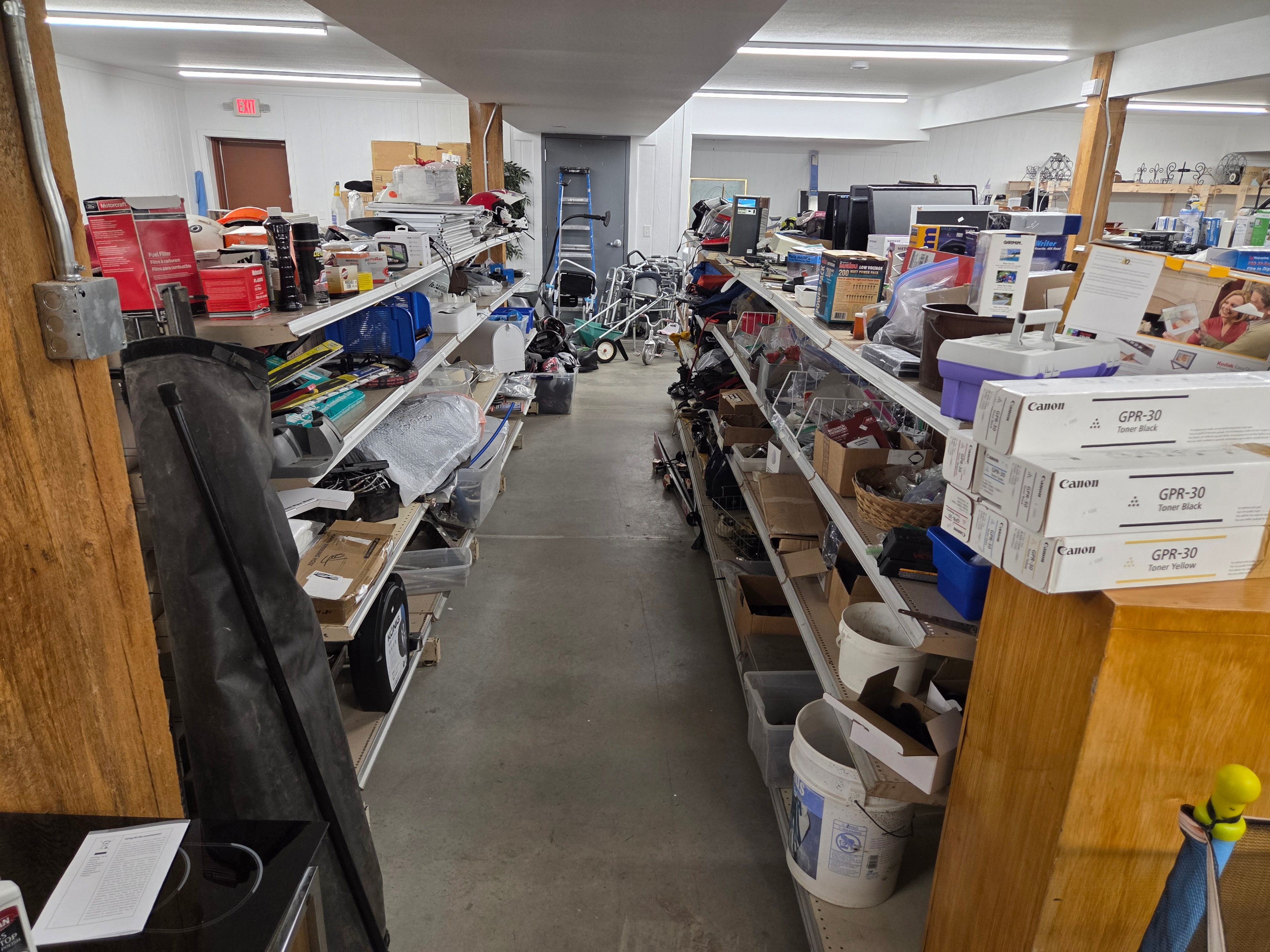 Basement aisle with tools, electronics, and supplies on shelves