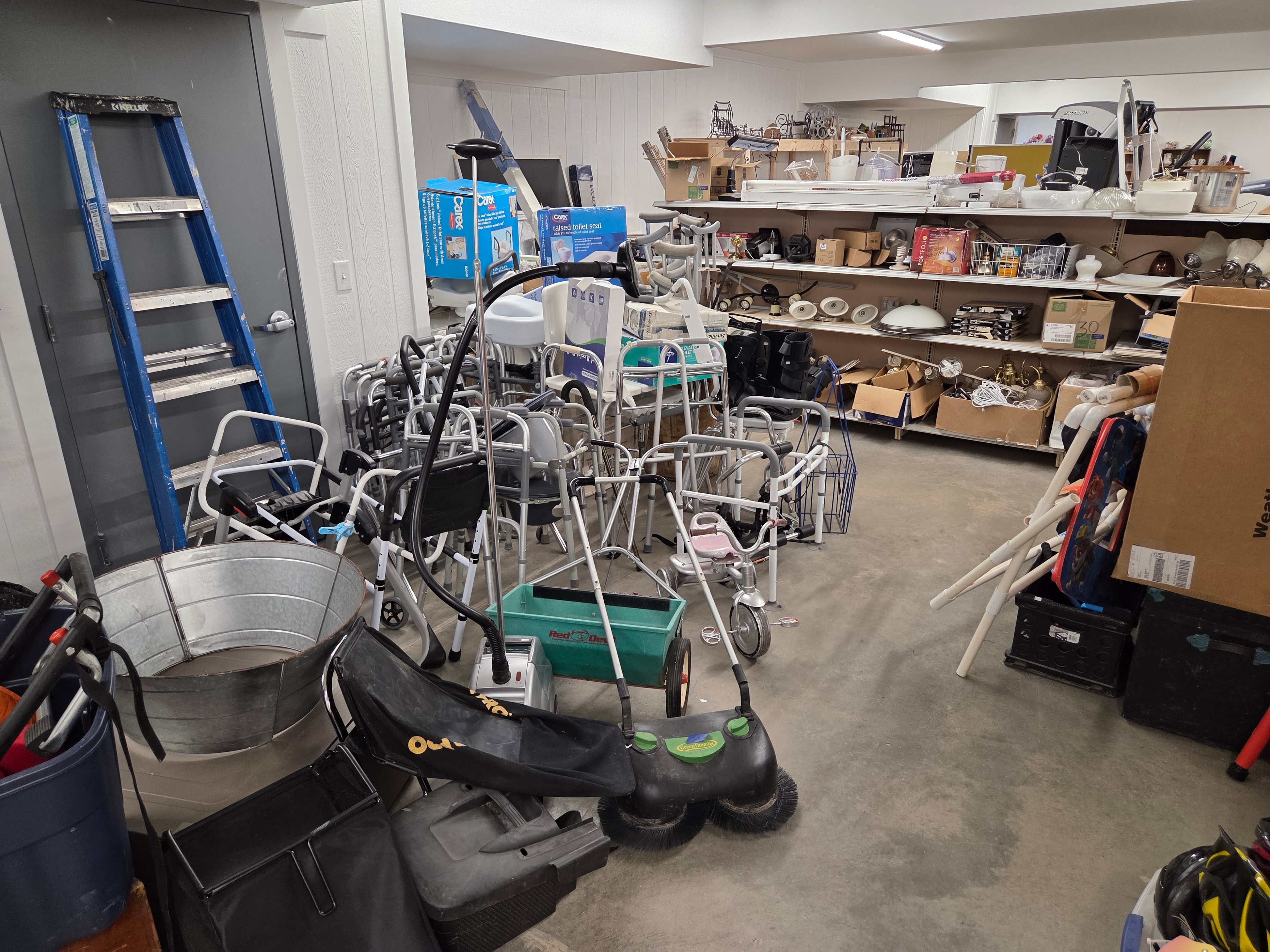 Mobility equipment, walkers, and household items in the basement