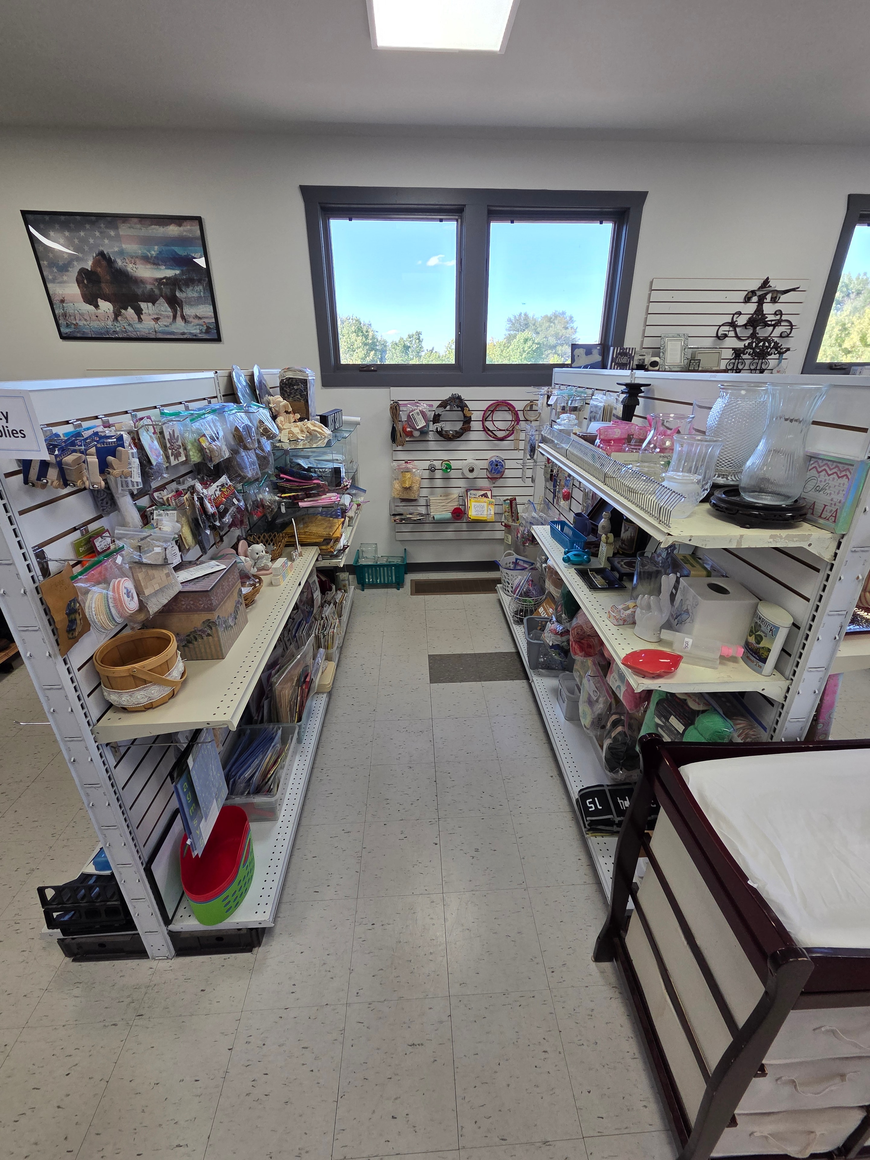 Main floor craft supplies, shelving, and assorted goods with natural light from windows