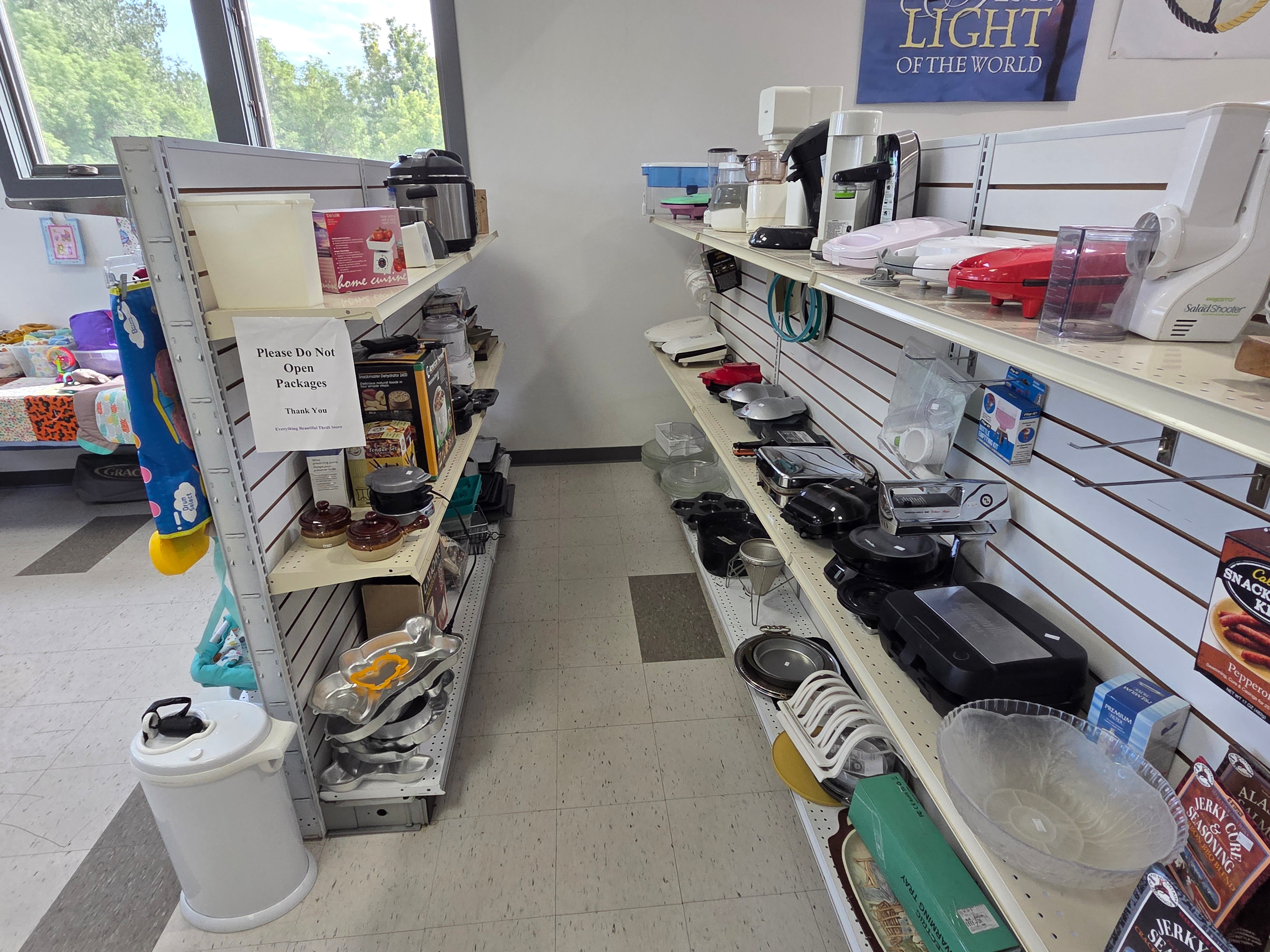 Main floor kitchen appliances and cookware on shelves